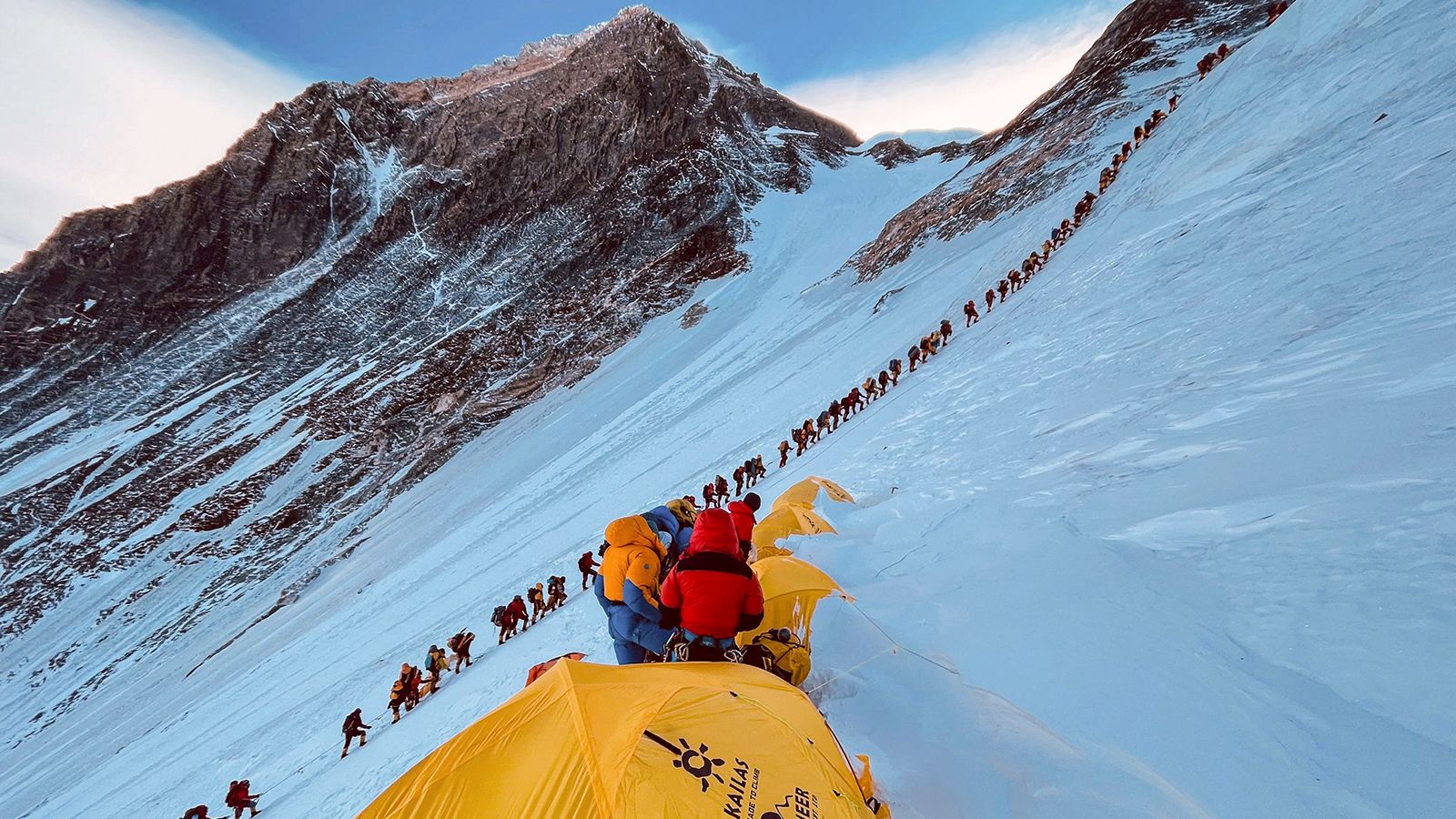 This photograph from 2021 shows mountaineers lined up as they climb a slope during their ascent to summit Mount Everest. Photo Credit: CNN