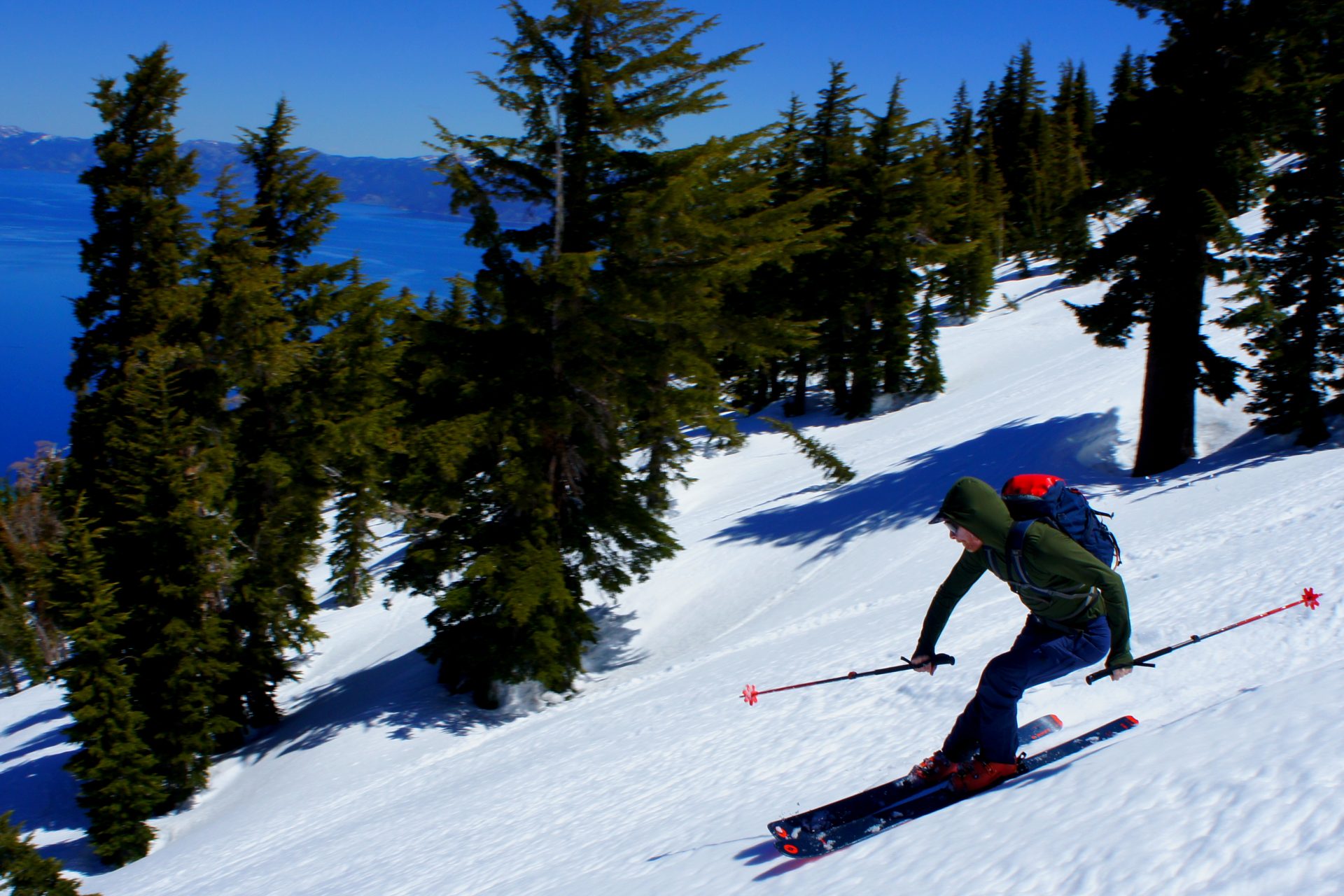 skier making turns in soft spring snow above lake tahoe