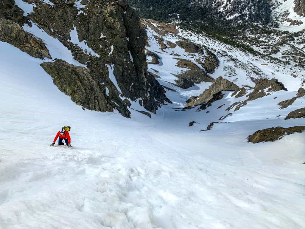 A climber ascending skywalker couloir on a snowy south arapahoe peak in colorado