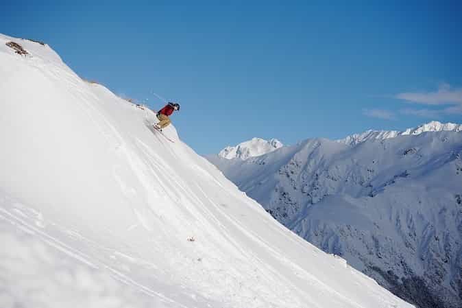 Skier on steep snowy mountain slope at Temple Basin, New Zealand