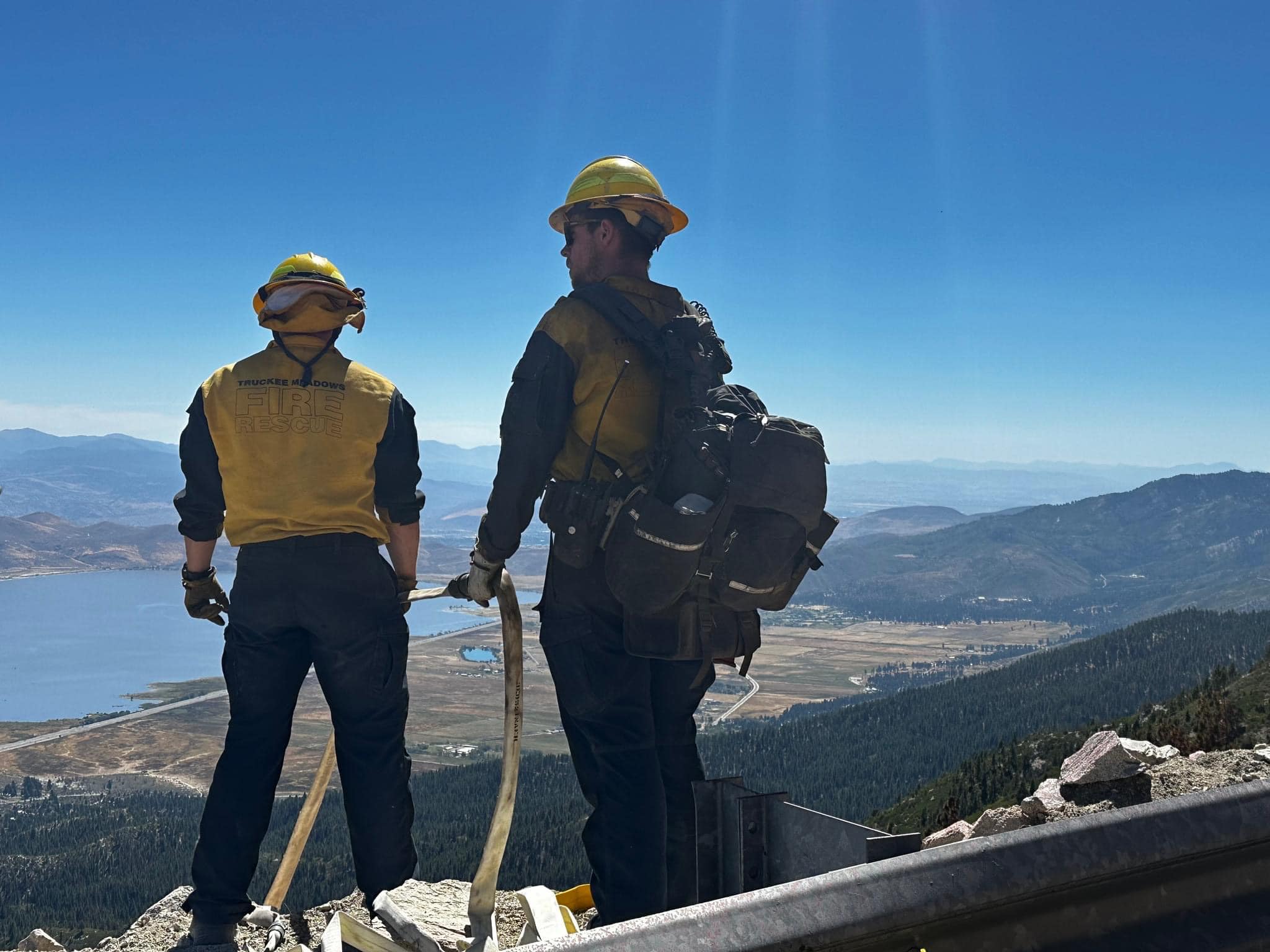 Firefighters standing above Davis Fire