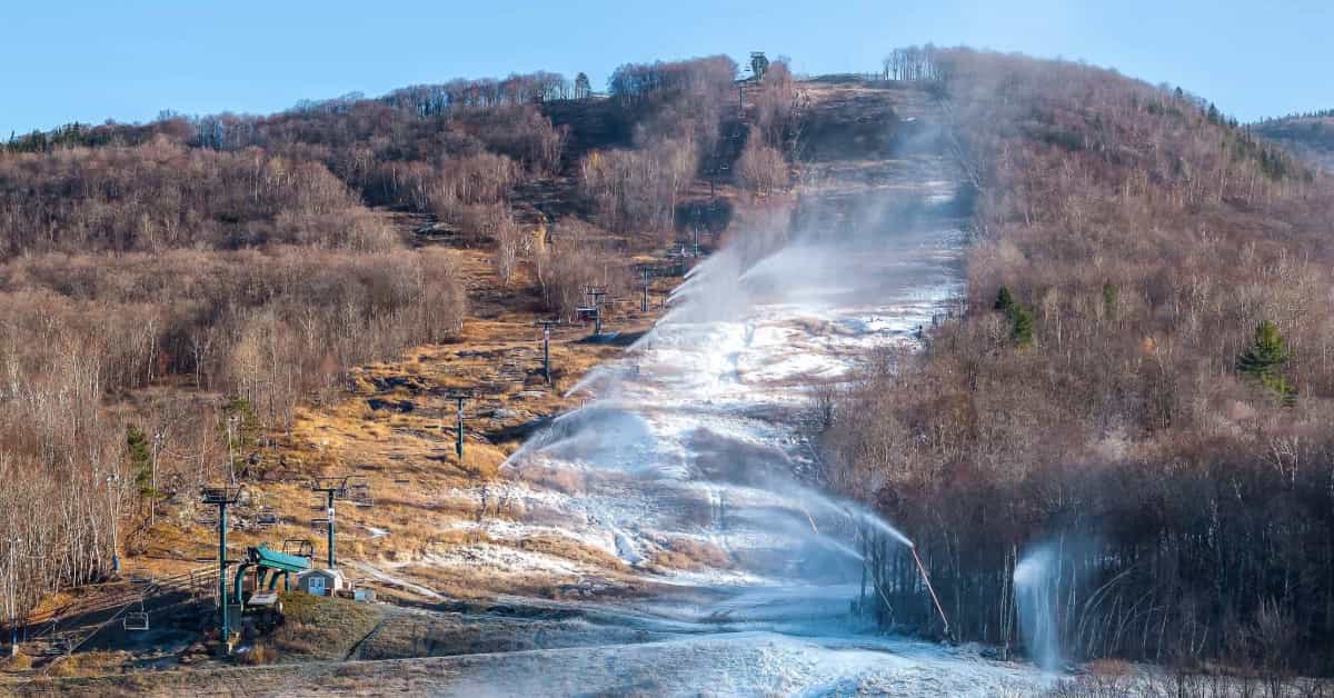 snowmaking on dry mountain slope at tremblant in quebec ahead of postponed opening day