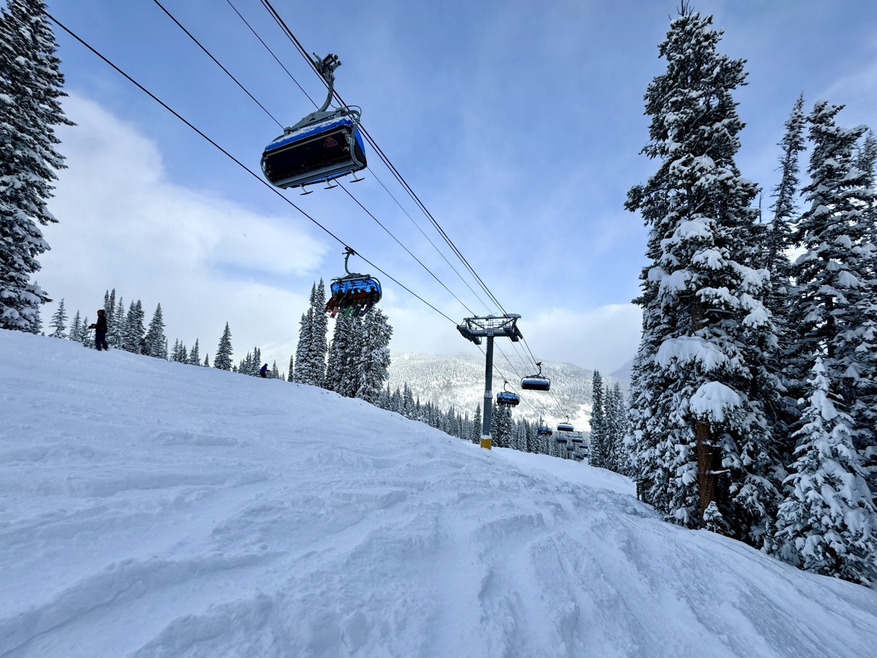 snow with ski tracks in under chairlift at copper mountain colorado