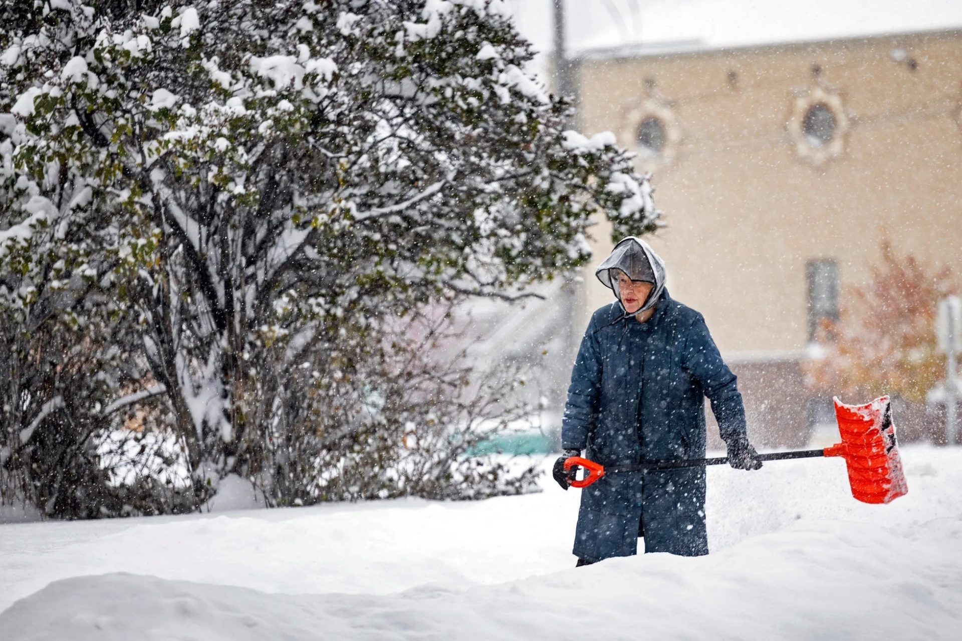 Lady in Montana shoveling snow