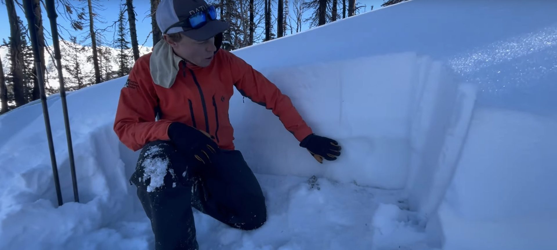 avalanche center employee describing layers in a snowpit