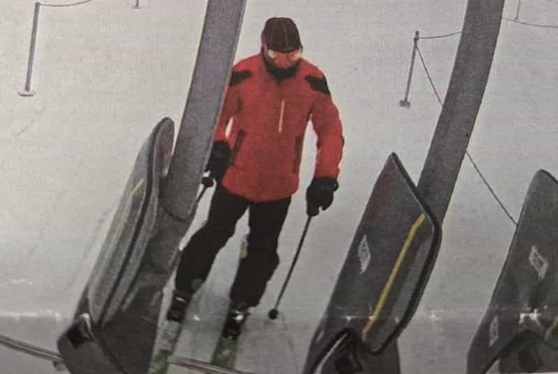 Skier Thomasz Jaholkowski in a red and black ski jacket, dark ski pants, and a dark toque, getting onto a ski lift before going missing at Sun Peaks Resort