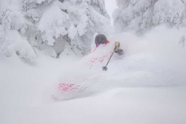 skier in deep powder face shot at big white