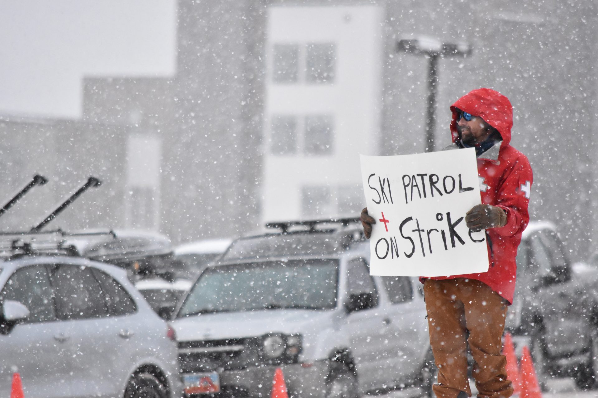 ski patroller with sign on strike