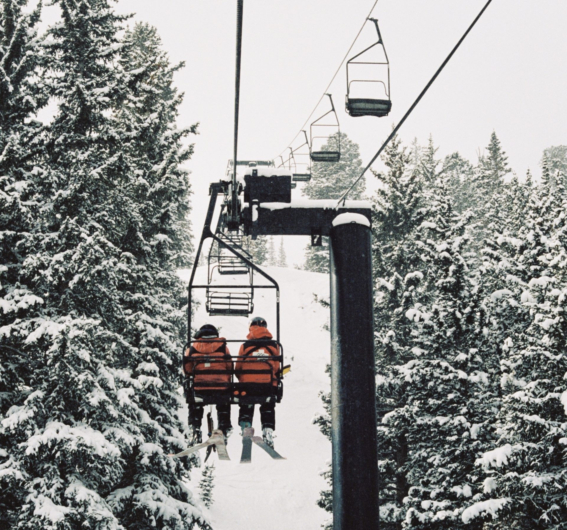 ski patrollers on chairlift